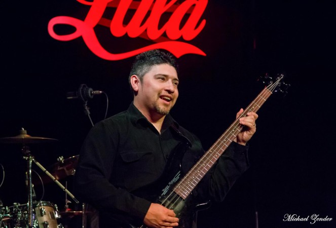 Photo of Cristian playing bass.